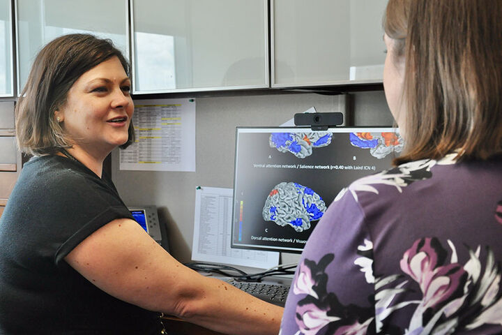 Psychiatry students review a series of brain scans.